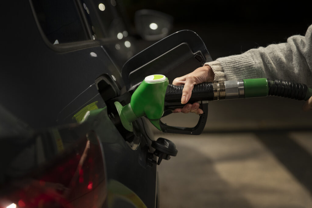 close up hand holding gas pump close up hand holding gas pump